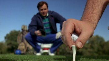 Movie still from “Coneheads” (1993), directed by Steve Barron – A person holding a golf ball and a golf club; Close Up shot, Low angle