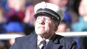 Movie still from “Coneheads” (1993), directed by Steve Barron – An older man wearing a hat and glasses; Close Up shot, Low angle