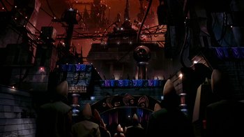 Movie still from “Coneheads” (1993), directed by Steve Barron – A group of people sitting in front of a stage; Wide shot, High angle