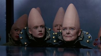 Movie still from “Coneheads” (1993), directed by Steve Barron – A group of people with odd hats on their heads; Close Up shot, High angle