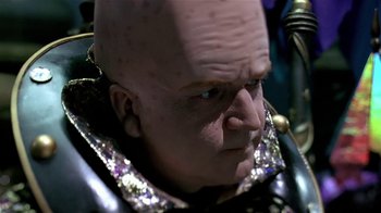 Movie still from “Coneheads” (1993), directed by Steve Barron – A man's face with a bald head; Close Up shot, Low angle