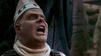 Movie still from “Coneheads” (1993), directed by Steve Barron – A man's face in a costume; Close Up shot, Low angle