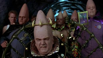 Movie still from “Coneheads” (1993), directed by Steve Barron – A bunch of people that are dressed like coneheads; Close Up shot, High angle