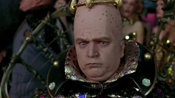 Movie still from “Coneheads” (1993), directed by Steve Barron – A person wearing a costume; Close Up shot, Low angle
