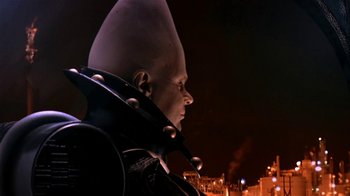 Movie still from “Coneheads” (1993), directed by Steve Barron – A man with a helmet on looking into the night sky; Close Up shot, Low angle