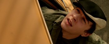 Movie still from “Constantine” (2005), directed by Francis Lawrence – A young man laying in the back of a car; Close Up shot, Overhead angle