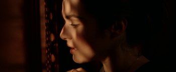 Movie still from “Constantine” (2005), directed by Francis Lawrence – A woman's face in the dark; Extreme Close Up shot, Over the shoulder angle