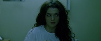 Movie still from “Constantine” (2005), directed by Francis Lawrence – A woman with long dark hair stares into the camera; Close Up shot, Over the shoulder angle