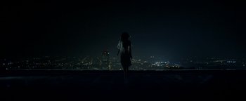 Movie still from “Constantine” (2005), directed by Francis Lawrence – A person standing on the side of a building at night; Extreme Wide shot, High angle