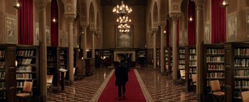 Movie still from “Constantine” (2005), directed by Francis Lawrence – A man walking down a red carpet in a library; Extreme Wide shot, High angle