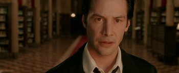Movie still from “Constantine” (2005), directed by Francis Lawrence – A man in a black jacket and a white shirt; Close Up shot, Low angle