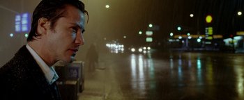 Movie still from “Constantine” (2005), directed by Francis Lawrence – A man standing on the side of a road at night; Close Up shot, Low angle