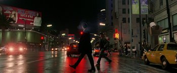 Movie still from “Constantine” (2005), directed by Francis Lawrence – Two men crossing a street at night with cars on the road; Wide shot, Low angle