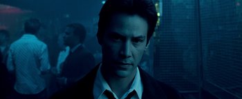 Movie still from “Constantine” (2005), directed by Francis Lawrence – A man in a suit and tie in the dark; Close Up shot, Low angle