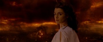 Movie still from “Constantine” (2005), directed by Francis Lawrence – A woman in a white shirt standing in front of a city; Close Up shot, Over the shoulder angle