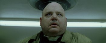 Movie still from “Constantine” (2005), directed by Francis Lawrence – A man with a bald head looking up at the ceiling; Close Up shot, Low angle