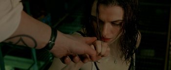 Movie still from “Constantine” (2005), directed by Francis Lawrence – A person putting something in her mouth; Close Up shot, Over the shoulder angle