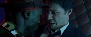 Movie still from “Constantine” (2005), directed by Francis Lawrence – A man in a suit and a hat looking at another man in a suit and a hat; Close Up shot, Overhead angle