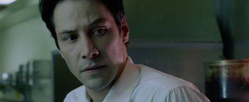 Movie still from “Constantine” (2005), directed by Francis Lawrence – A person wearing a white dress shirt; Close Up shot, Low angle