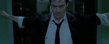 Movie still from “Constantine” (2005), directed by Francis Lawrence – A person wearing a suit and tie; Close Up shot, Low angle