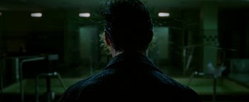 Movie still from “Constantine” (2005), directed by Francis Lawrence – The back of a man's head in a dark room; Close Up shot, Over the shoulder angle