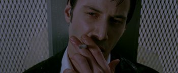 Movie still from “Constantine” (2005), directed by Francis Lawrence – A person smoking a cigarette; Close Up shot, Low angle