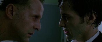 Movie still from “Constantine” (2005), directed by Francis Lawrence – Two men face to face in a dark room; Close Up shot, Over the shoulder angle