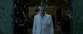 Movie still from “Constantine” (2005), directed by Francis Lawrence – A man in a white suit standing in front of a bunch of money; Medium shot, Low angle