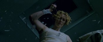 Movie still from “Constantine” (2005), directed by Francis Lawrence – A woman with curly blonde hair is holding a hair brush; Close Up shot, Low angle