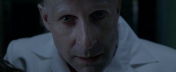 Movie still from “Constantine” (2005), directed by Francis Lawrence – A person's face in a dark room; Extreme Close Up shot, Overhead angle