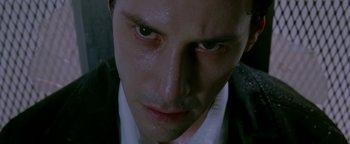 Movie still from “Constantine” (2005), directed by Francis Lawrence – A man's face in a dark room; Close Up shot, Low angle