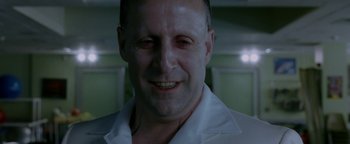 Movie still from “Constantine” (2005), directed by Francis Lawrence – A person wearing a white shirt smiling; Close Up shot, Over the shoulder angle