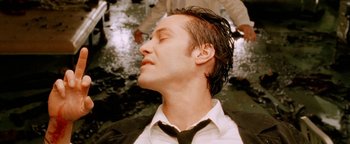 Movie still from “Constantine” (2005), directed by Francis Lawrence – A man with his eyes closed with his hands behind his head; Close Up shot, High angle