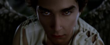 Movie still from “Constantine” (2005), directed by Francis Lawrence – A person's face with yellow eyes; Extreme Close Up shot, Low angle
