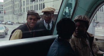 Movie still from “Cooley High” (1975), directed by Michael Schultz – A group of people in a car looking out of the window; Medium shot, Over the shoulder angle