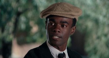 Movie still from “Cooley High” (1975), directed by Michael Schultz – A man wearing a hat and a suit; Close Up shot, Over the shoulder angle