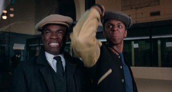Movie still from “Cooley High” (1975), directed by Michael Schultz – Two black men wearing hats and jackets; Close Up shot, Low angle