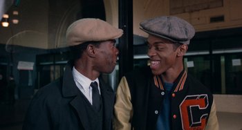 Movie still from “Cooley High” (1975), directed by Michael Schultz – Two young men are talking and laughing together; Close Up shot, Over the shoulder angle