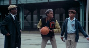Movie still from “Cooley High” (1975), directed by Michael Schultz – A man holding a basketball in his hands; Medium shot, Low angle