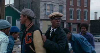 Movie still from “Cooley High” (1975), directed by Michael Schultz – A group of people walking down a street; Medium shot, Over the shoulder angle