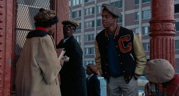 Movie still from “Cooley High” (1975), directed by Michael Schultz – A group of young men standing next to each other on a sidewalk; Medium shot, Over the shoulder angle