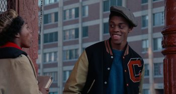 Movie still from “Cooley High” (1975), directed by Michael Schultz – A young man in a baseball jacket and a hat; Medium shot, Over the shoulder angle