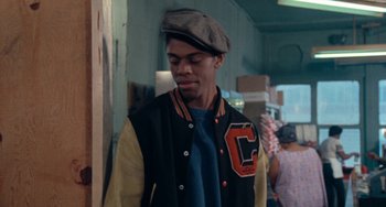 Movie still from “Cooley High” (1975), directed by Michael Schultz – A young man wearing a baseball jacket and a hat; Close Up shot, Over the shoulder angle