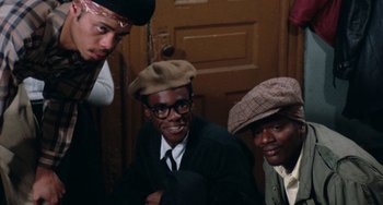 Movie still from “Cooley High” (1975), directed by Michael Schultz – A group of young men sitting next to each other; Medium shot, High angle