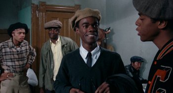Movie still from “Cooley High” (1975), directed by Michael Schultz – A young man wearing a hat and a tie; Medium shot, Low angle