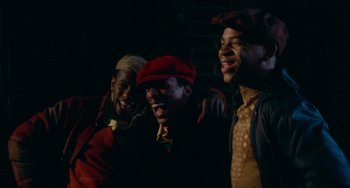 Movie still from “Cooley High” (1975), directed by Michael Schultz – A group of men standing next to each other in the dark; Medium shot, High angle