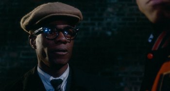 Movie still from “Cooley High” (1975), directed by Michael Schultz – A person wearing glasses and a hat; Close Up shot, Over the shoulder angle
