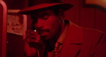 Movie still from “Cooley High” (1975), directed by Michael Schultz – A man wearing a hat talking on a phone; Close Up shot, Low angle