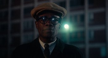Movie still from “Cooley High” (1975), directed by Michael Schultz – A man wearing glasses and a hat with a light shining on his head; Close Up shot, Low angle
