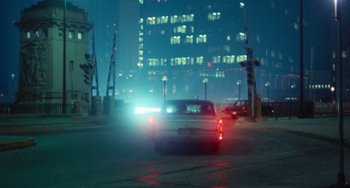 Movie still from “Cooley High” (1975), directed by Michael Schultz – A car driving down a street at night with lights on; Extreme Wide shot, Over the shoulder angle